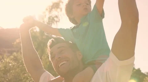 Father with son on shoulders in park. Stock Footage