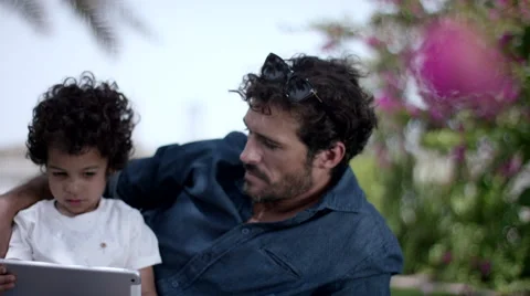 Father with son using digital tablet at park. Stock Footage 63510180