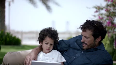 Father with son using digital tablet at park. Stock Footage 63510251