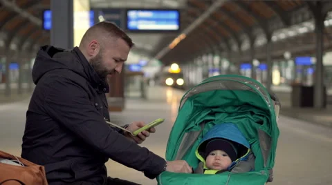 Father with son using mobile on station  Stock Footage 60662446