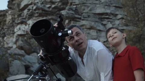 Father with son using telescope Stock Footage