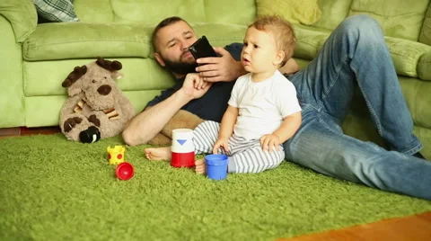 Father is spending time with son, talking for cellphone Stock Footage