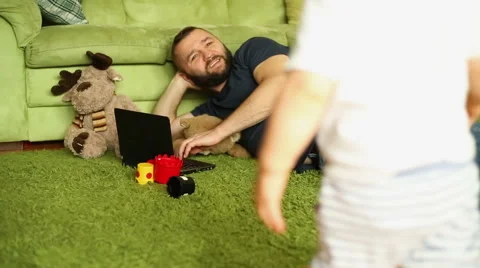 Father is spending time with son, working on a laptop Stock Footage 67690919