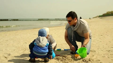 Father spends time with children at the beach Stock Footage 63376205
