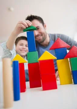 Father stacking blocks with his son (8-9) Stock Photos
