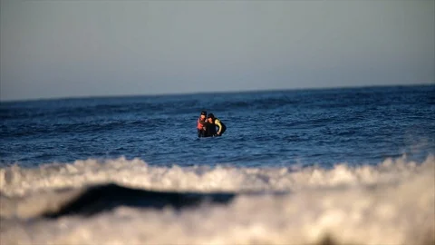 Father surfing with his two young daughters. Stockbeeldmateriaal 88406138