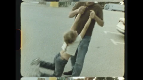 Father swinging child by the arms in empty lot on super 8 film Stock-Footage 337814867