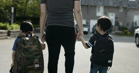 Father taking his two sons to school. Holding their hands lovingly. Stock Footage 131122029