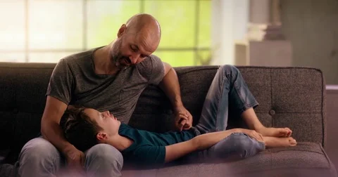 Father talking to his son on the couch Stock Footage 78662171