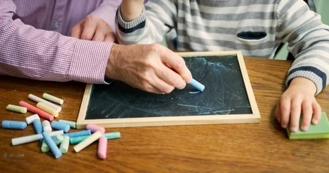 Father Teaches Young Boy To Write Using Chalk Stock Footage 100042941