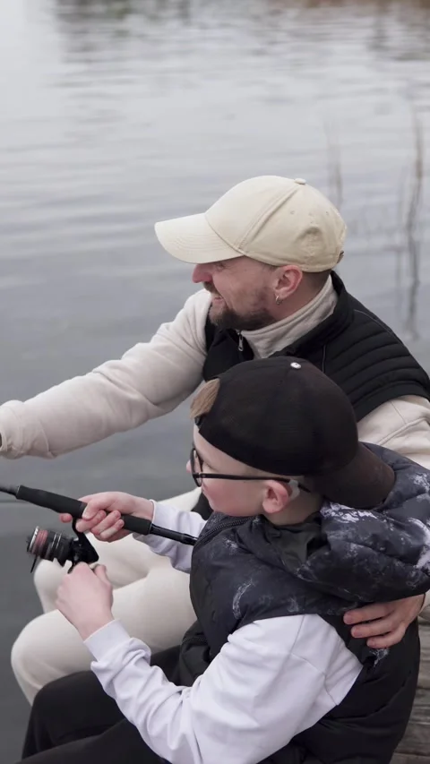 Father teaching child how to fish. Family and fatherhood concept. Stock Footage 308071787