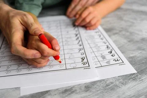 Father teaching child to write letters Stock Photos