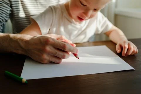 Father teaching child to write or draw Stock Photos