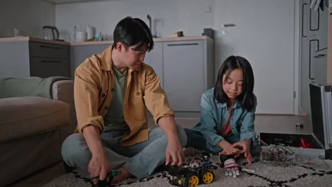 Father teaching daughter about STEM, robotics, and discussing technology. Stock Footage 310209803