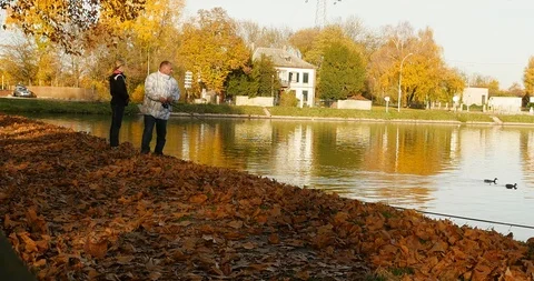 Father teaching daughter how to fish and bait Stock Footage 89843680