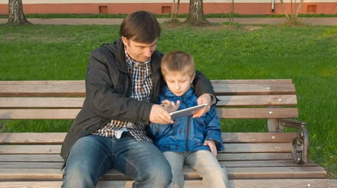 Father teaching his cute young son to use a tablet Stock Footage 62789086