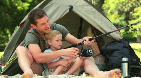 Father teaching his son how to fish Stock Footage 2915668