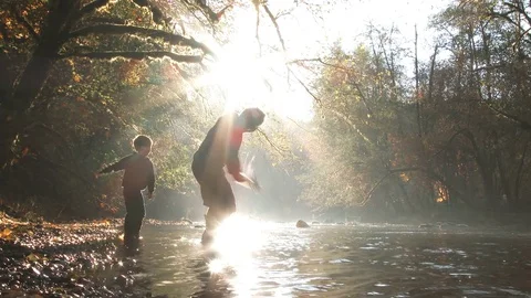 Father Teaching His Son How To Skip Rocks Stock Footage 81916969