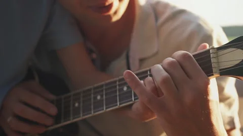 Father teaching his son how to play the guitar in outdoor Stock Footage 124090614