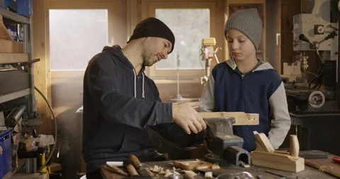 Father teaching his son some craftsmen techniques Stock Footage 85659492