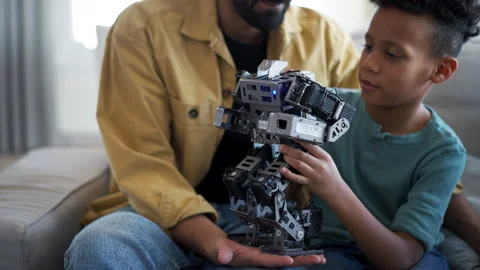 Father teaching son about STEM, robotics, and discussing technology. Stock Footage 310209432