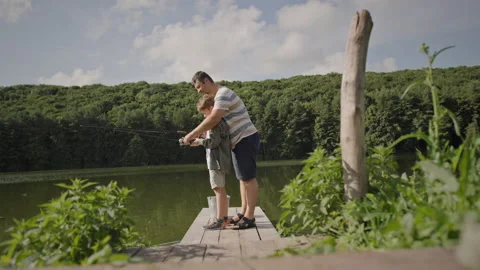 Father teaching son to fish Stock Footage 209288423