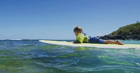 Father teaching son to surf tandem surfing Stock Footage 77639348
