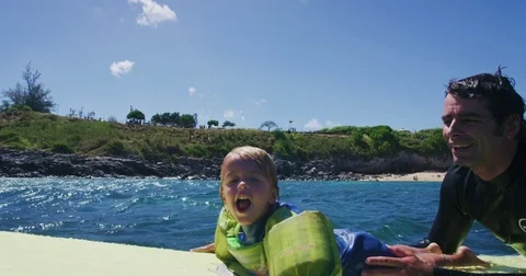 Father teaching son to surf tandem surfing Stock Footage 77639366