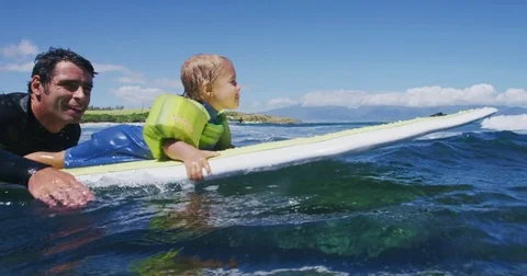 Father teaching son to surf tandem surfing Stock Footage 77639796