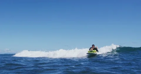 Father teaching son to surf tandem surfing Stock Footage 77640309