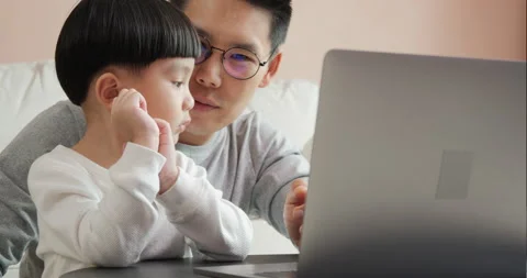 Father teaching son to use tablet at home. Stock Footage 131892322