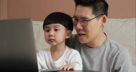 Father teaching son to use tablet at home. Stock Footage 131892659