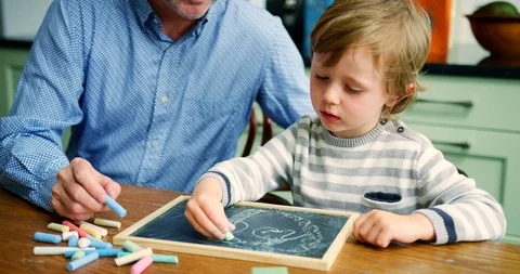 Father Teaching Son To Write Using Chalk And Blackboard Stock Footage 100042979