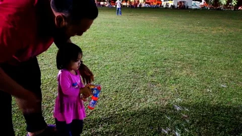 A father teaching a toddler using the soap bubble machine. Stock Footage 333906511