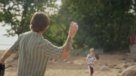Father Throwing Baseball to Son Playing Catch on Sandy Beach Stock Footage 340258676