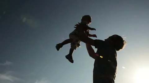Father throwing his kid up in the air on the park Stock Footage 12573278
