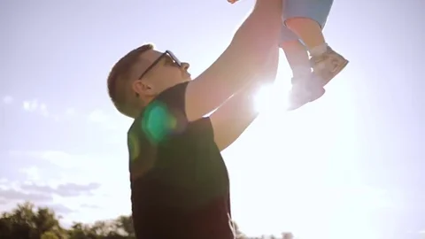 The father throws the little son up. Stock Footage 77527633