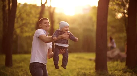 Father throws  playing with young son on nature in park 1 Stock-Footage 55116230