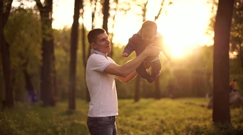 Father throws  playing with young son on nature in park 3 Stock Footage 55116257