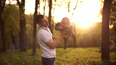 Father throws  playing with young son on nature in park 4 Stock Footage 55116829
