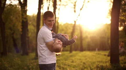Father throws  playing with young son  on nature in park 2 Stock Footage 55116891