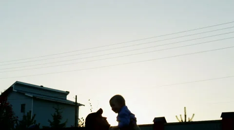 Father Tossing Up His Son at Sunset Stock Footage 56261735