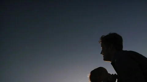 Father tossing toddler son up into the air Stock Footage