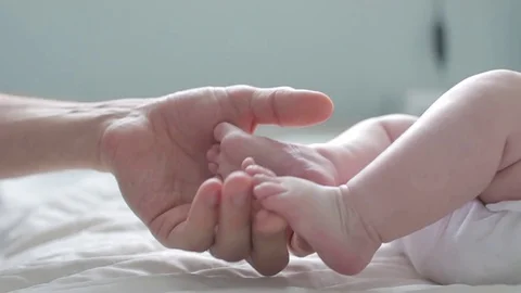 Father touching and counting his Newborn Baby's little toes. Close Up. Parent Stock Footage 101276946