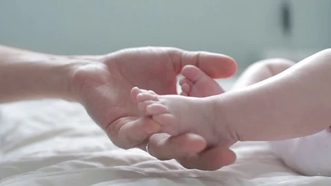 Father touching and counting his Newborn Baby's little toes. Close Up. Parent Stock Footage 101277020
