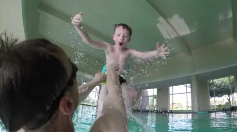 Father trowing his son in the pool Stock Footage 50237626