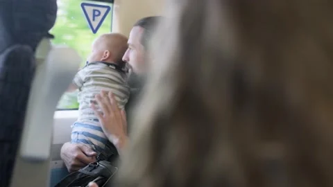 Father with two sons looking out the window at running landscapes. Traveling Stock Footage 220738653