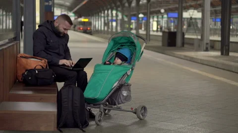 Father using laptop on station , stroller 스톡 동영상 60662946