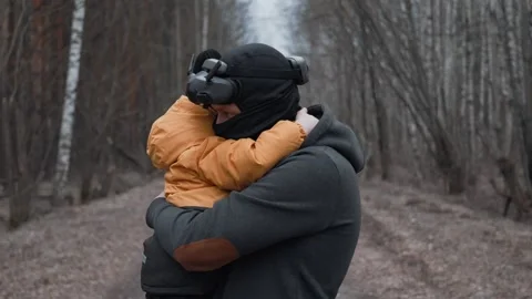 Father Using VR Headset While Holding Son in Arms in Enchanted Forest - Virtual  Stock Footage 305322399