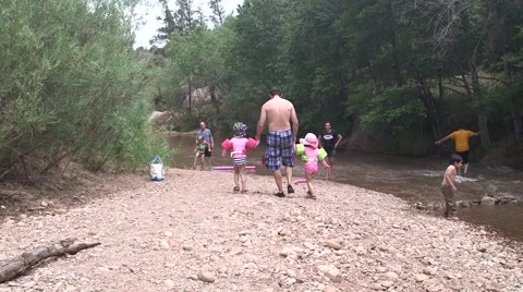 Father walking daughters on riverbed Stock Footage 43386535